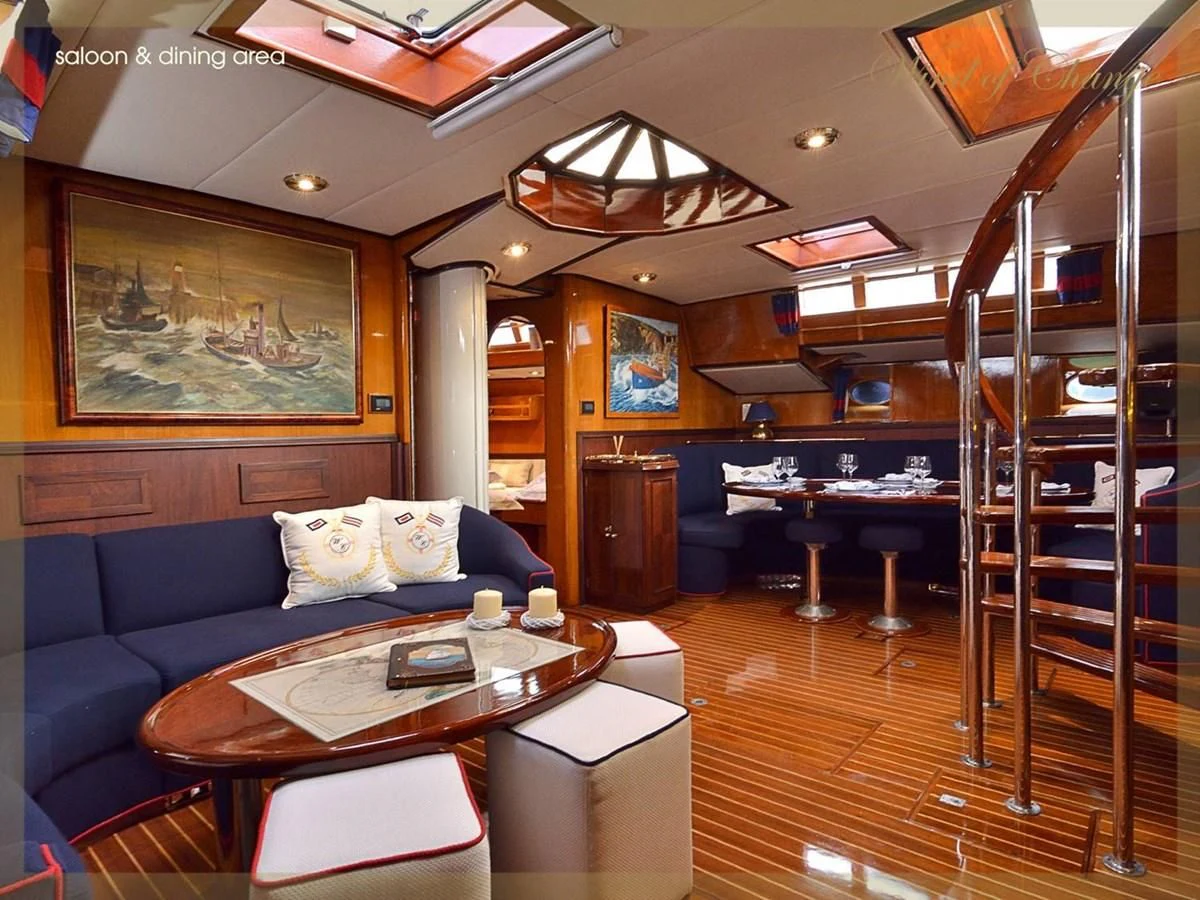 a living room with a blue couch aboard WIND OF CHANGE Yacht for Charter