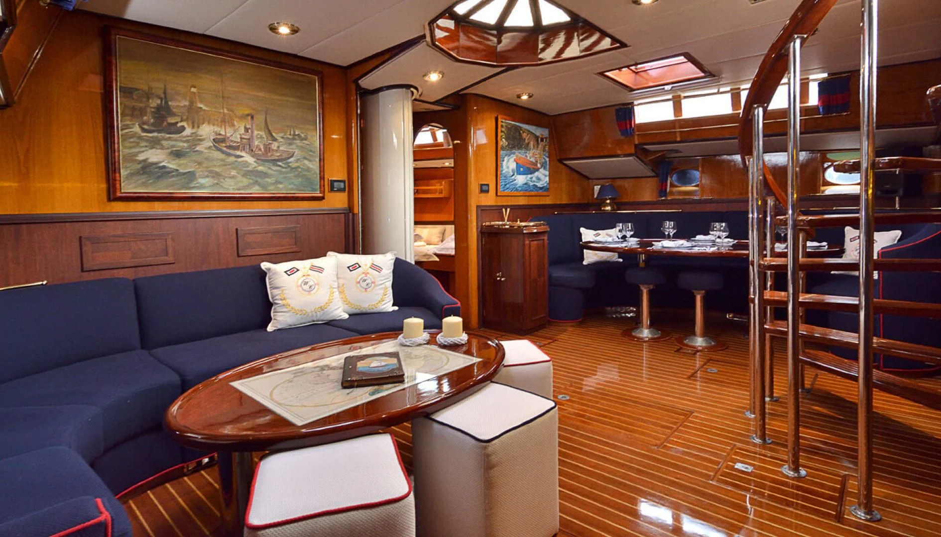 a living room with a blue couch and a table aboard WIND OF CHANGE Yacht for Charter