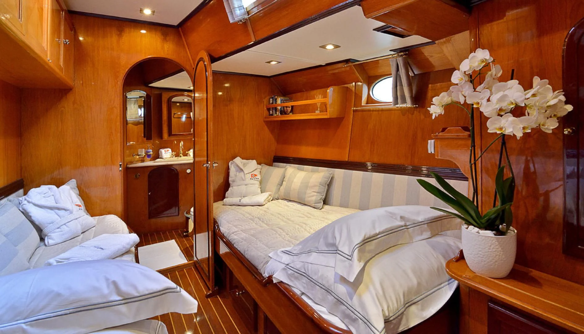 a room with a bed and a plant in it aboard WIND OF CHANGE Yacht for Charter