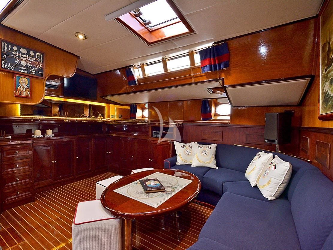 a living room with wood cabinets aboard WIND OF CHANGE Yacht for Charter