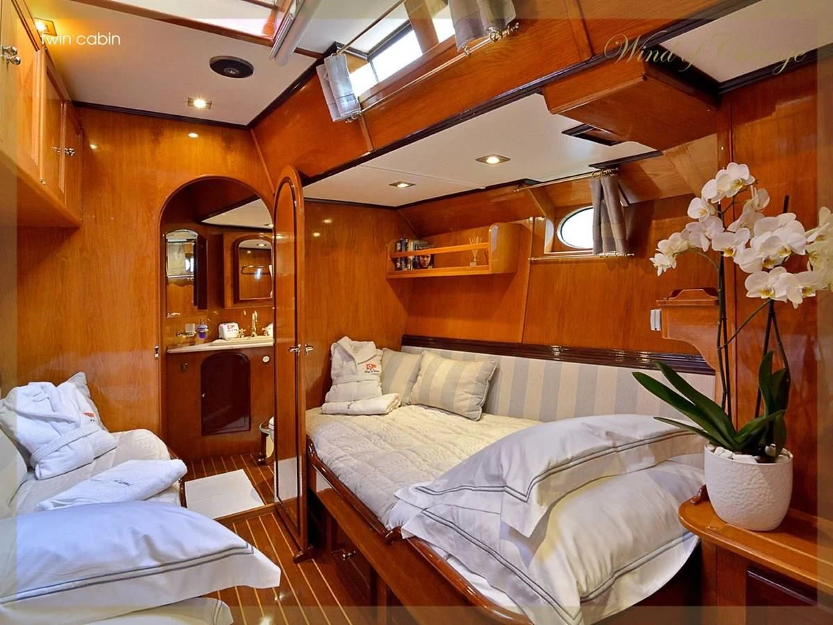 a room with a bed and a plant in it aboard WIND OF CHANGE Yacht for Charter