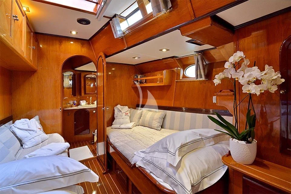 a room with a bed and a plant in it aboard WIND OF CHANGE Yacht for Charter