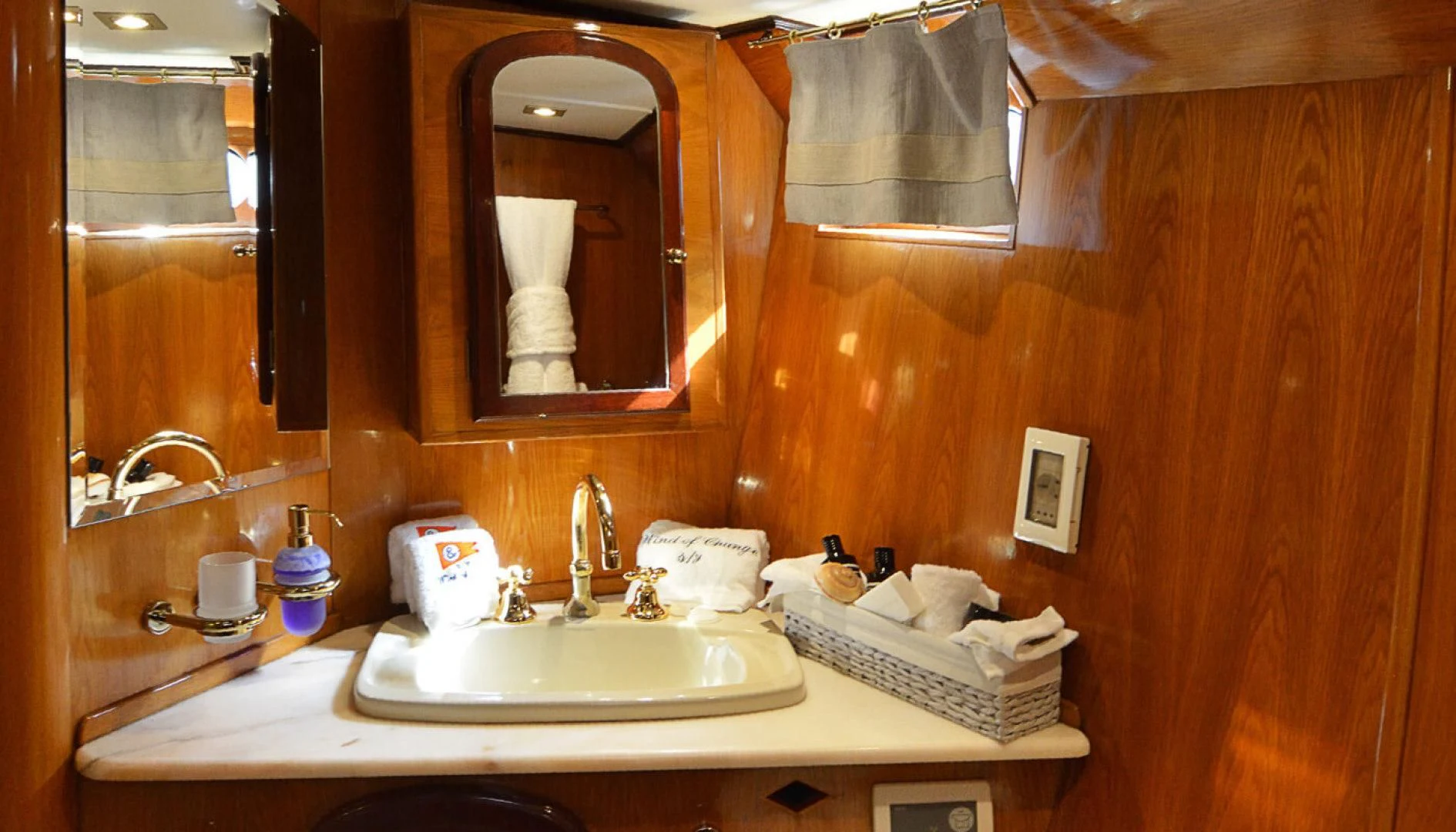 a bathroom with a mirror and a sink aboard WIND OF CHANGE Yacht for Charter