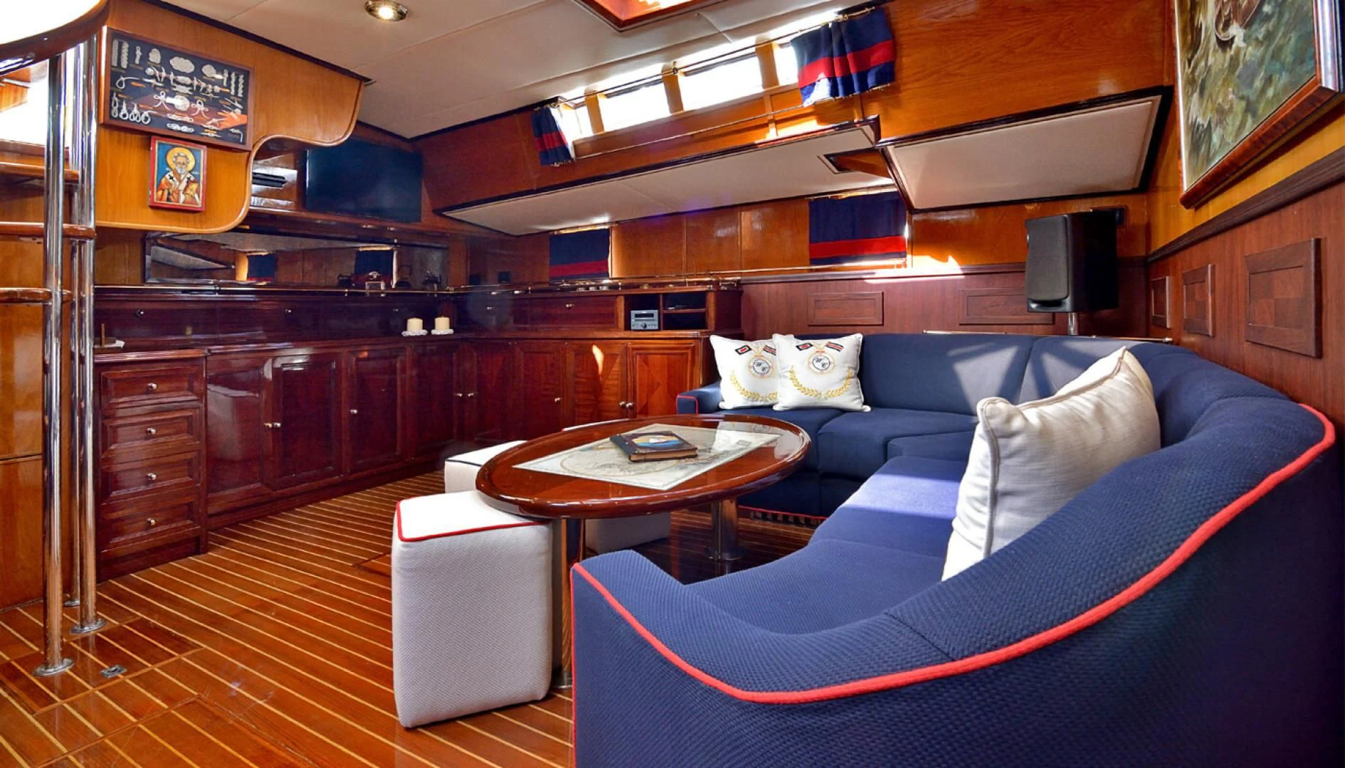 a living room with a blue couch aboard WIND OF CHANGE Yacht for Charter