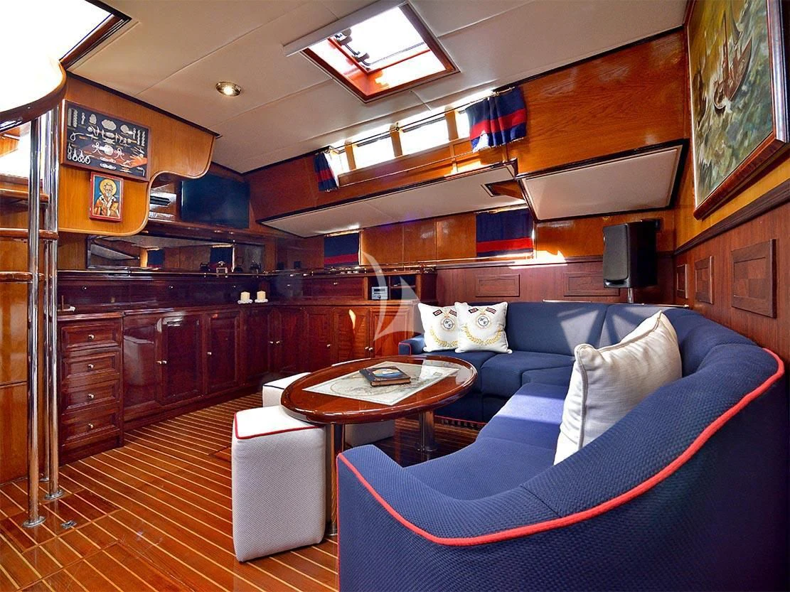 a living room with a blue couch aboard WIND OF CHANGE Yacht for Charter