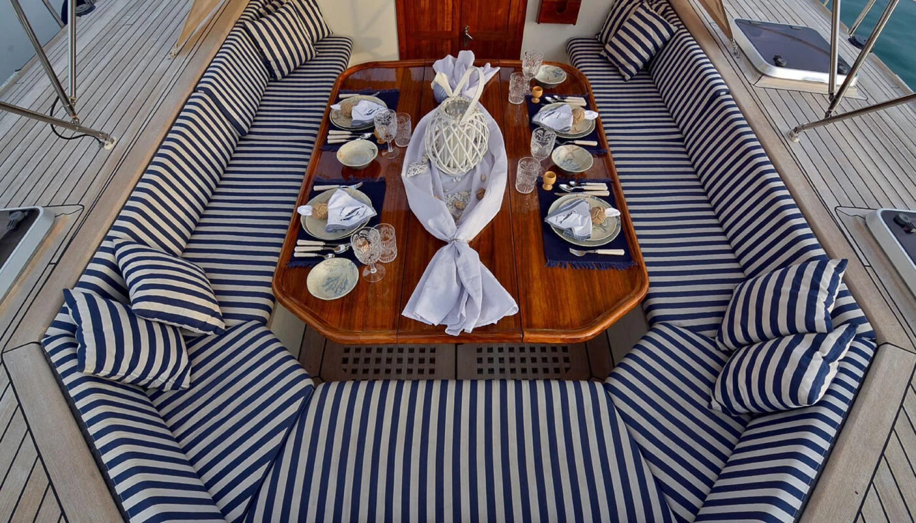 a table with plates and cups on it aboard WIND OF CHANGE Yacht for Charter