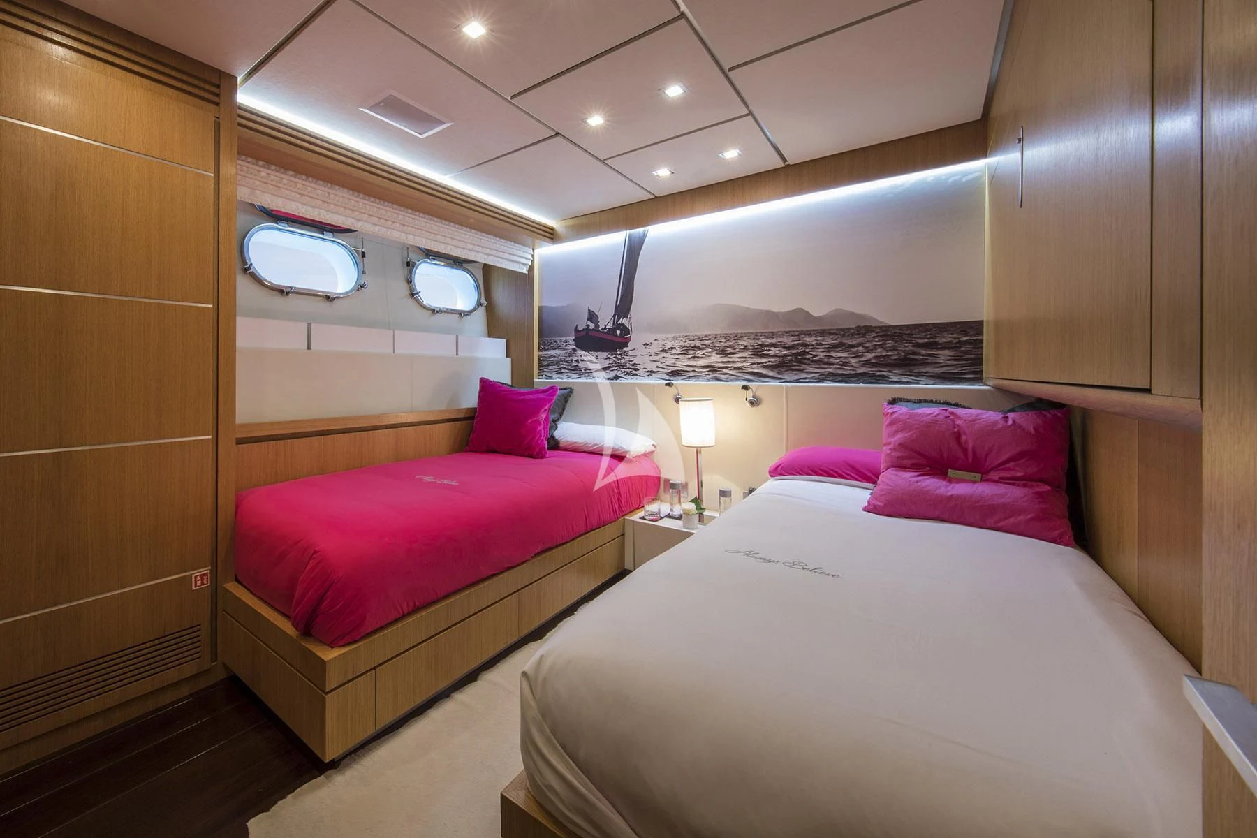 a room with a bed and a mirror aboard ALWAYS BELIEVE Yacht for Sale