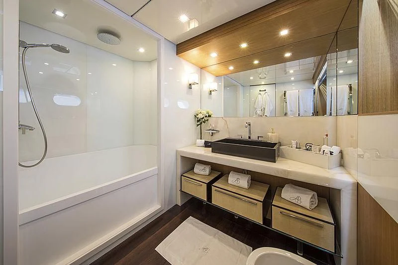 a bathroom with a large mirror aboard ALWAYS BELIEVE Yacht for Sale