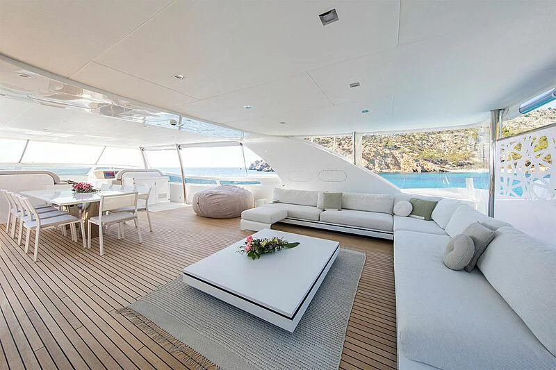 a modern living room with a large window aboard ALWAYS BELIEVE Yacht for Sale