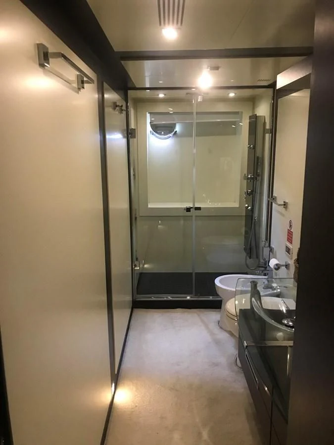 a bathroom with a glass shower aboard PATRIOT Yacht for Sale