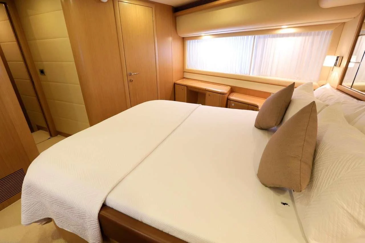 a bed with pillows aboard ONYX Yacht for Charter