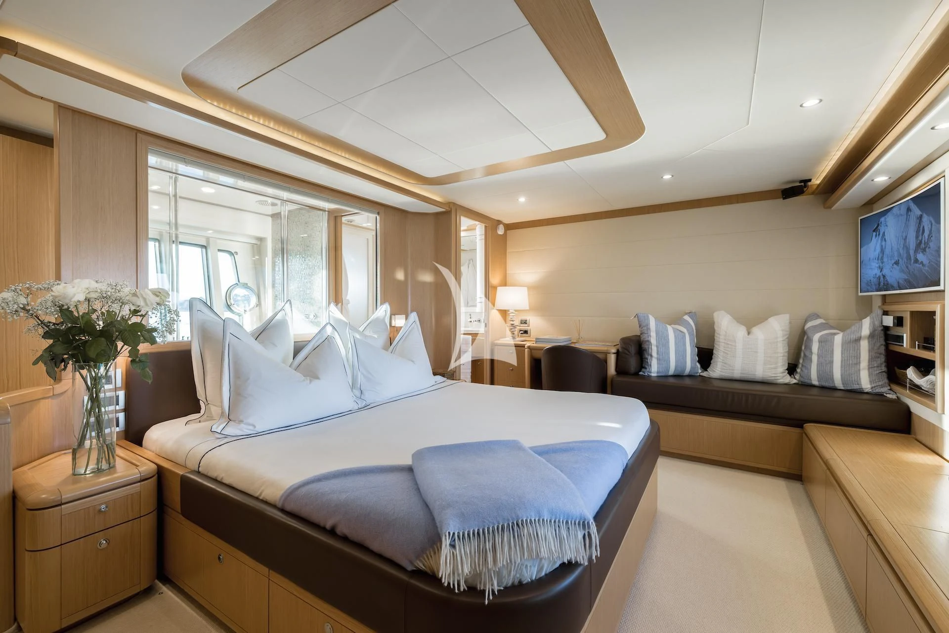 a bedroom with a bed and a couch aboard ONYX Yacht for Charter