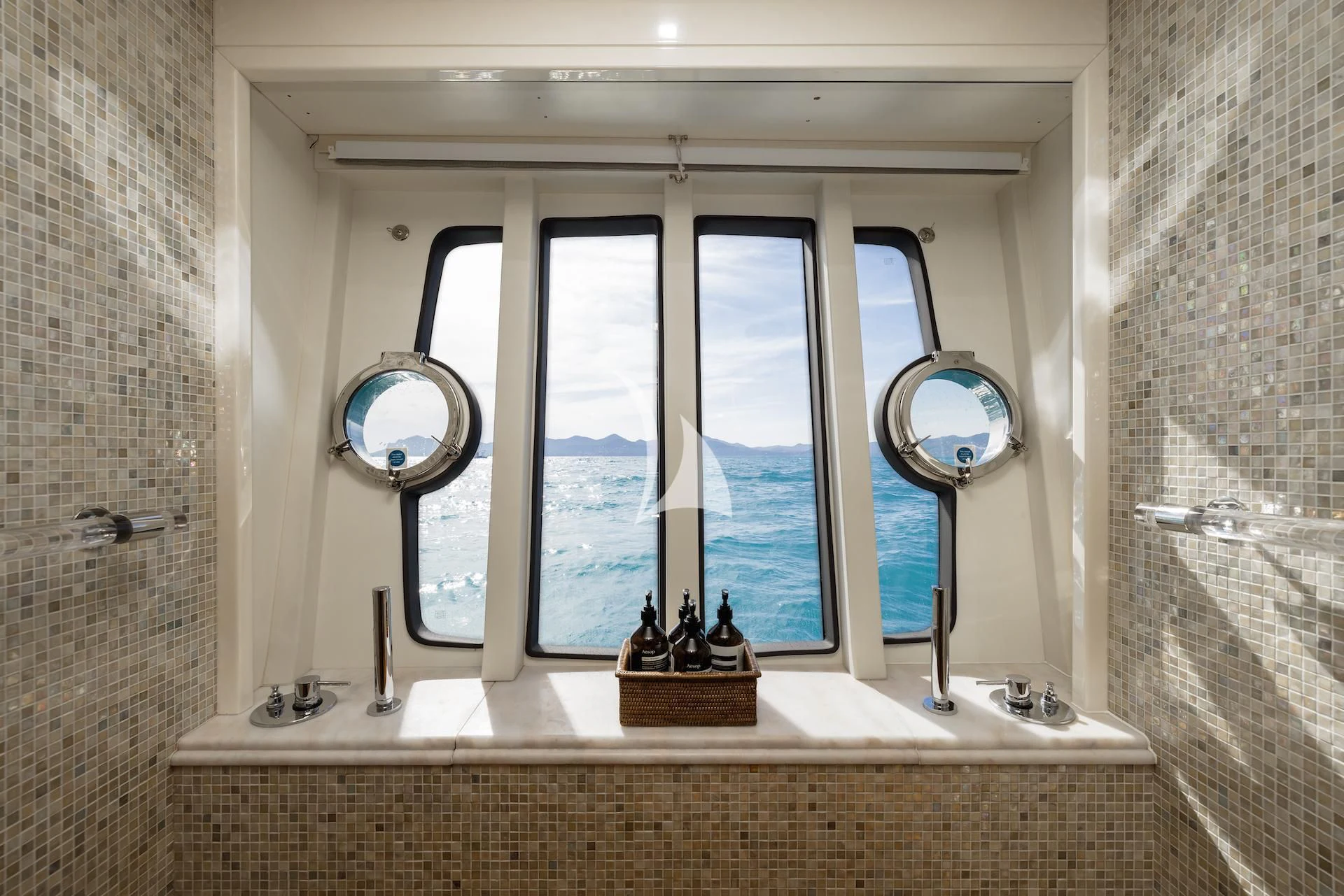 a window with a mirror and a sink in it aboard ONYX Yacht for Charter