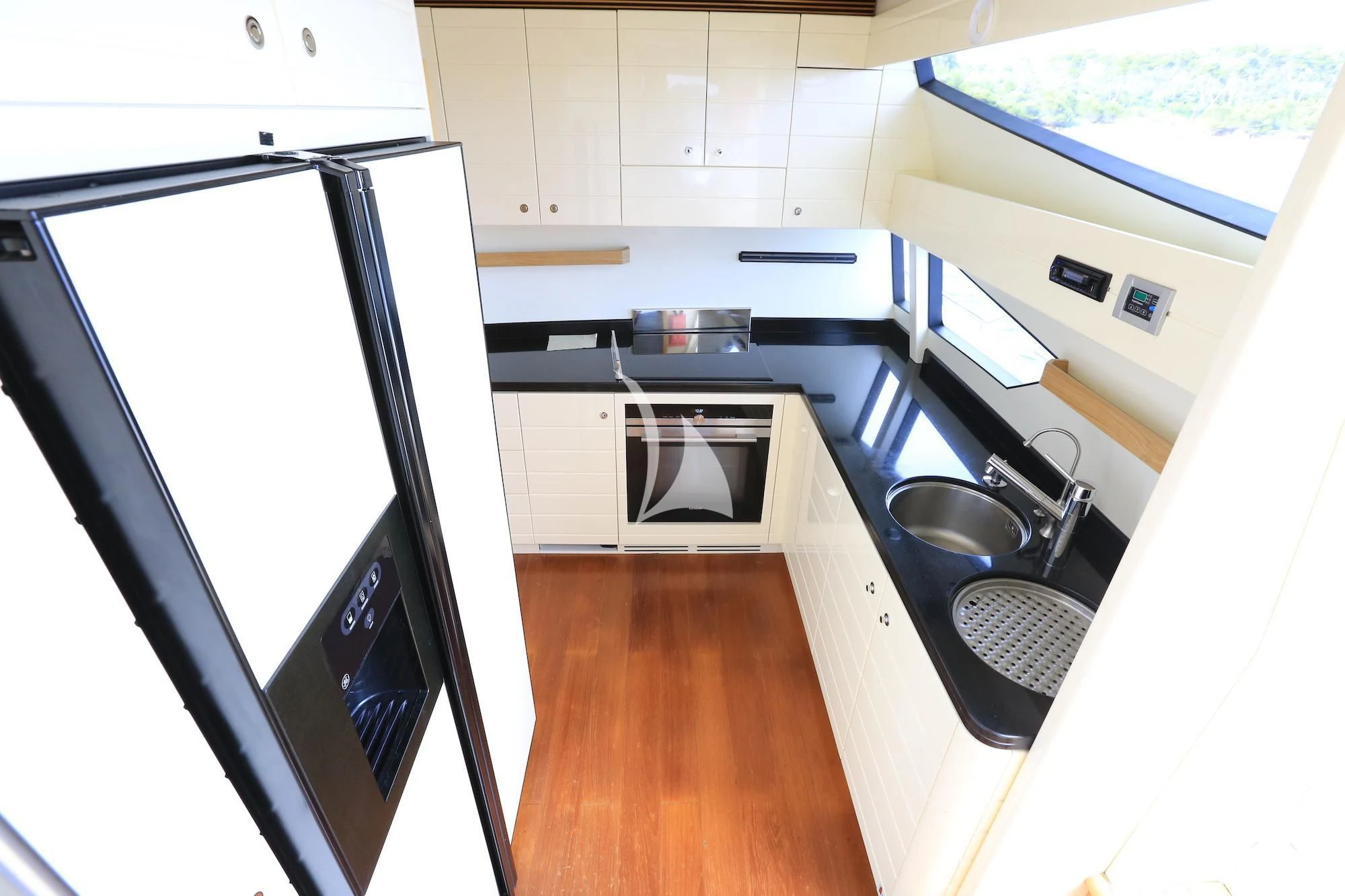 a kitchen with a large refrigerator aboard ONYX Yacht for Charter