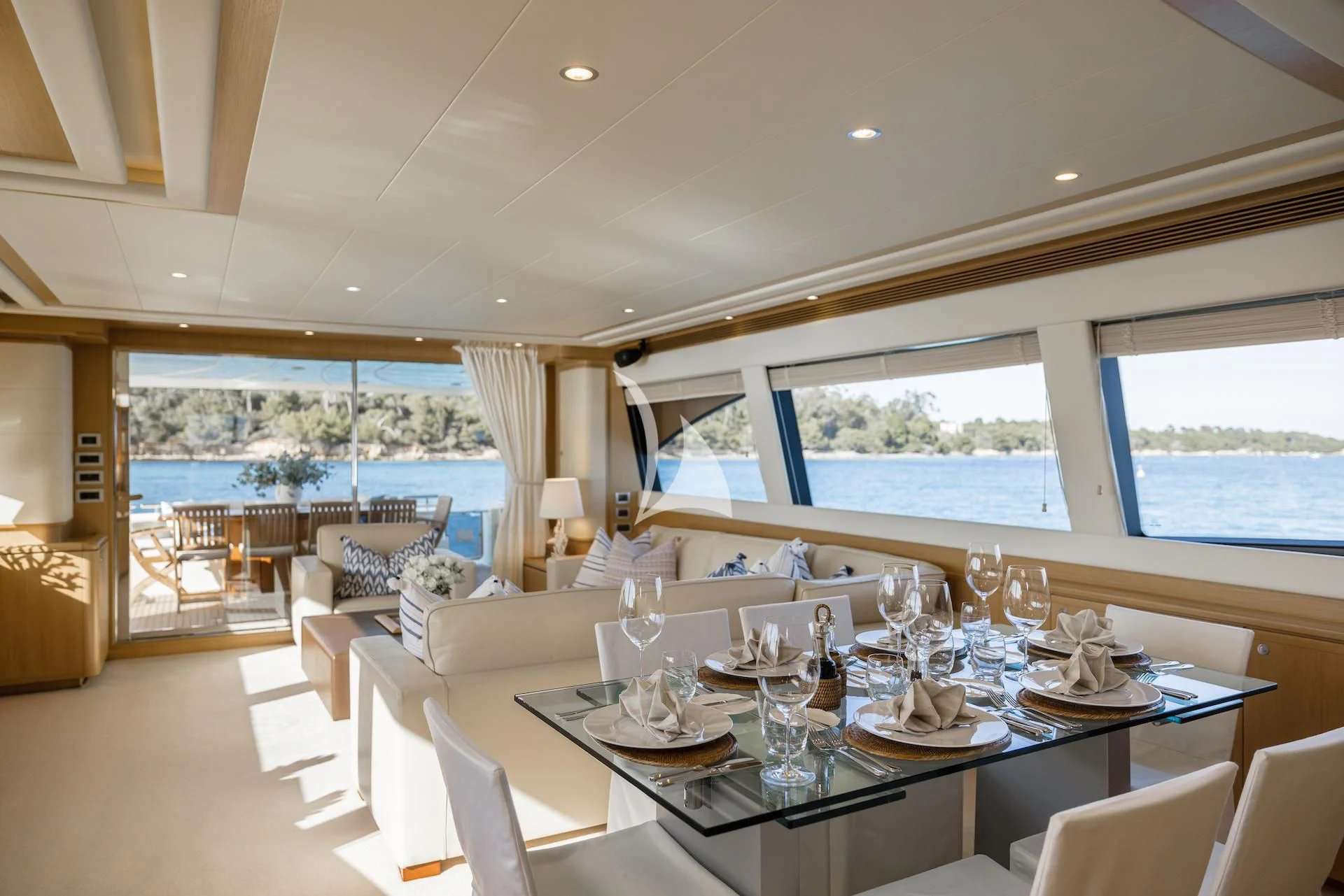 a dining room with a large window aboard ONYX Yacht for Charter