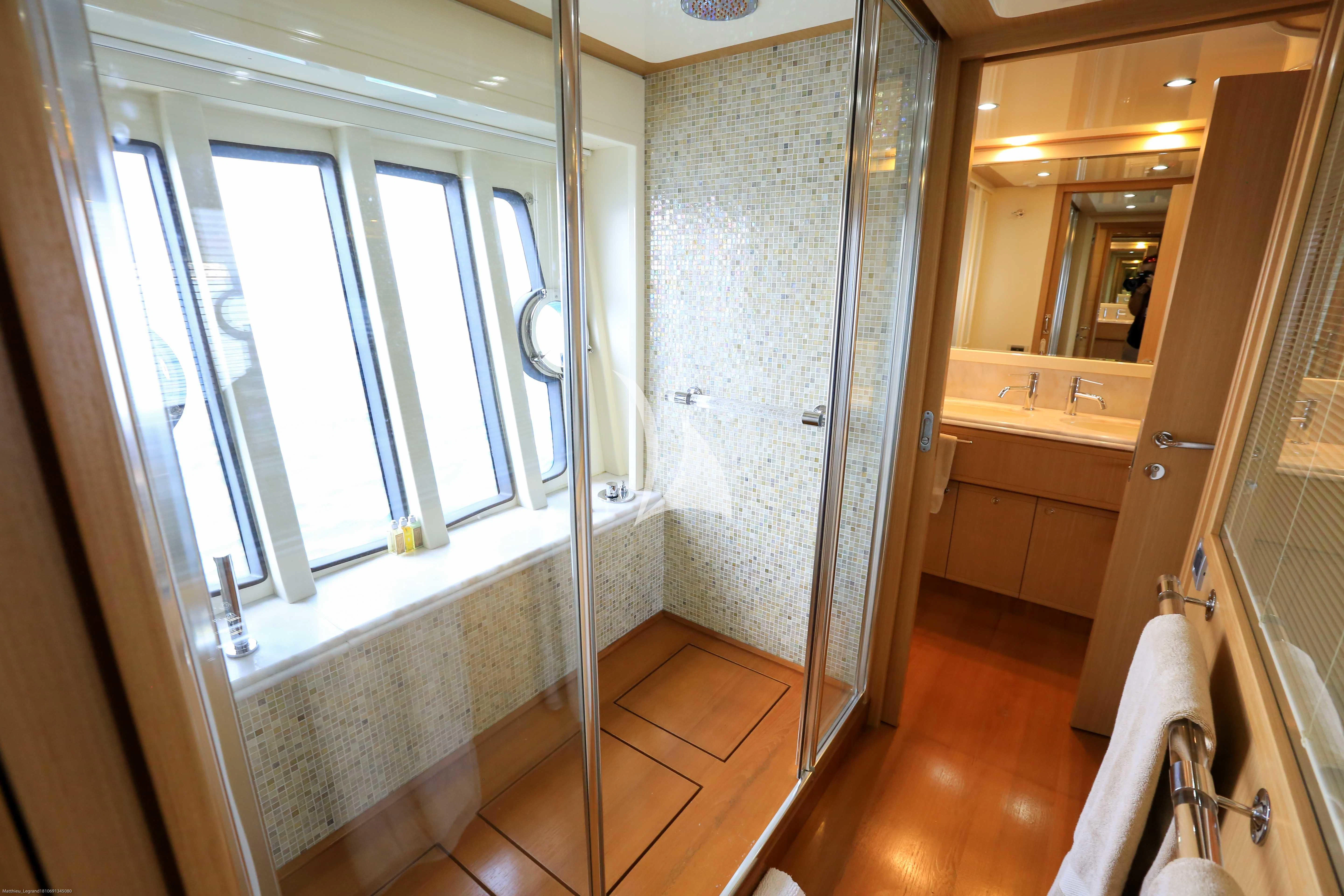 a bathroom with a shower and sink aboard ONYX Yacht for Charter