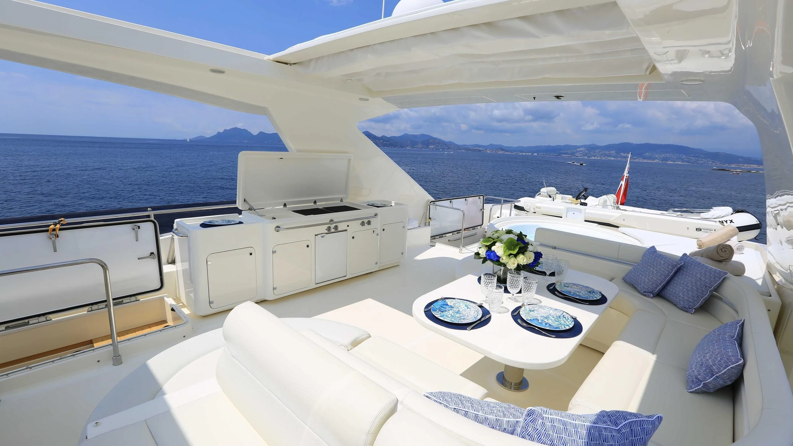 a room with a large bed and a table with plates on it aboard ONYX Yacht for Charter