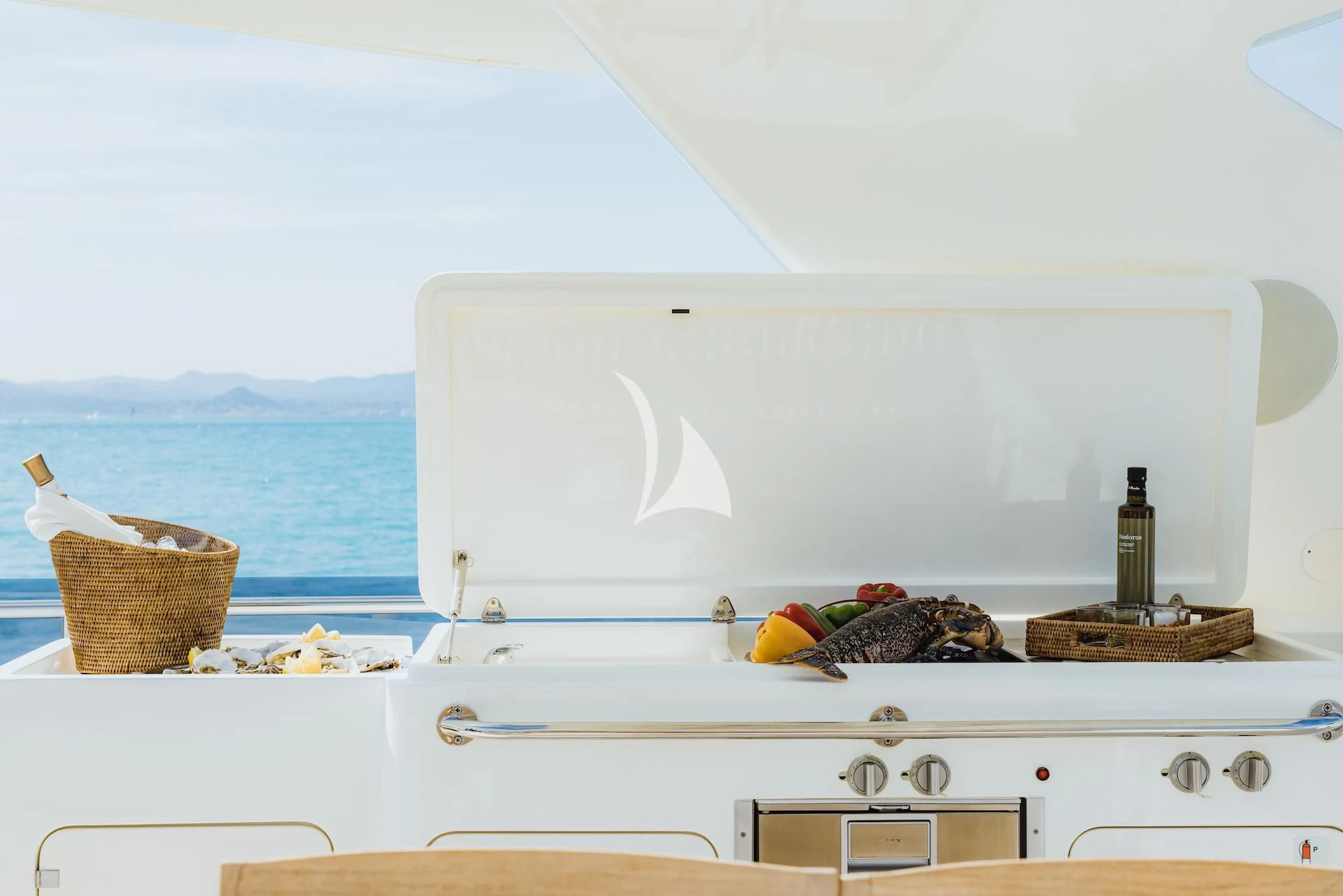 a white kitchen with a basket and a basket on the counter aboard ONYX Yacht for Charter