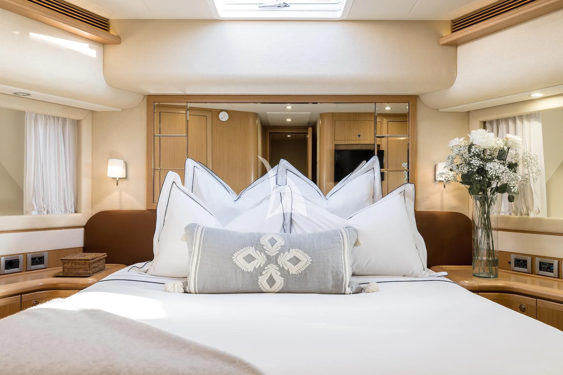 a bed with white sheets and pillows aboard ONYX Yacht for Charter