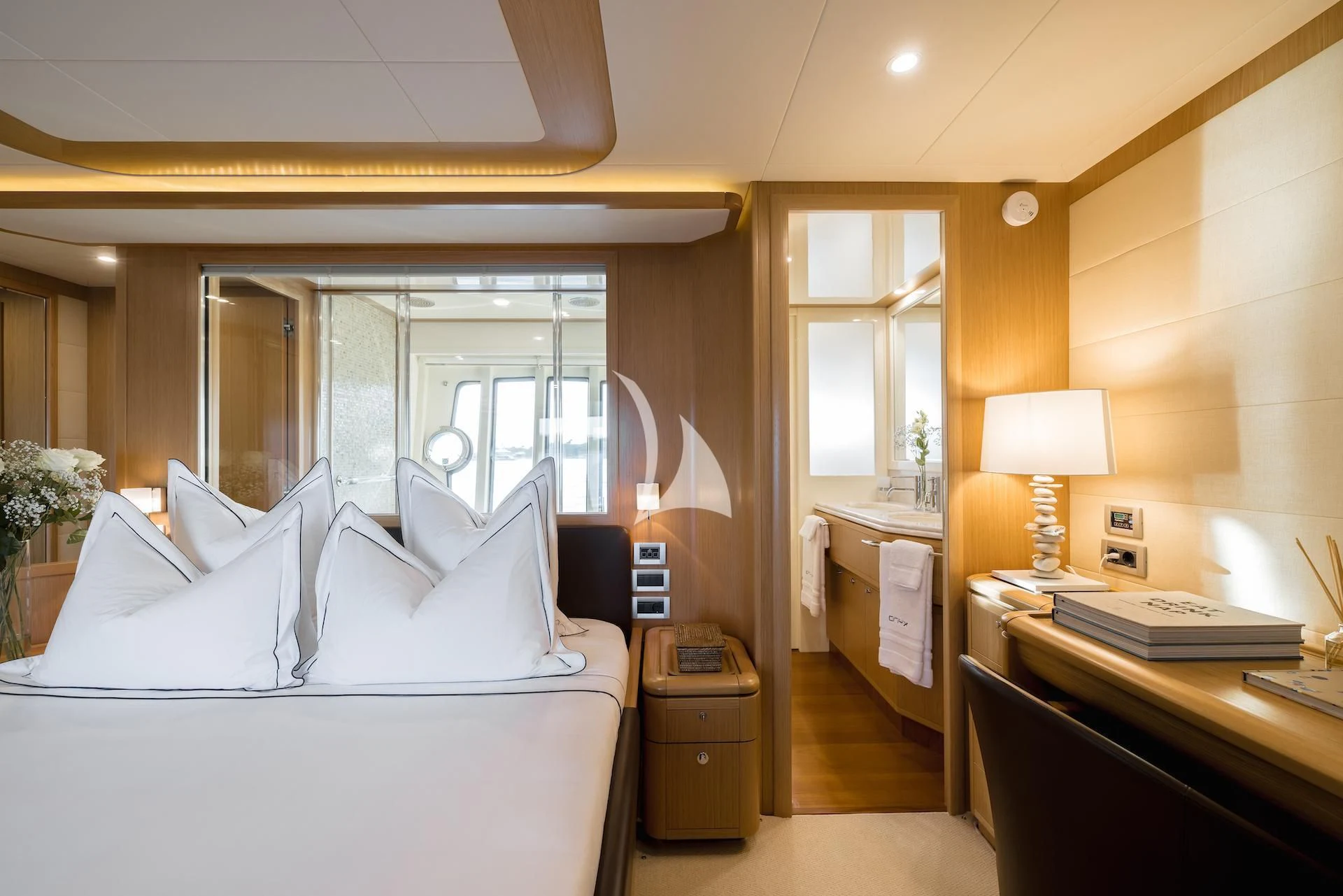 a bedroom with a bed and a desk aboard ONYX Yacht for Charter