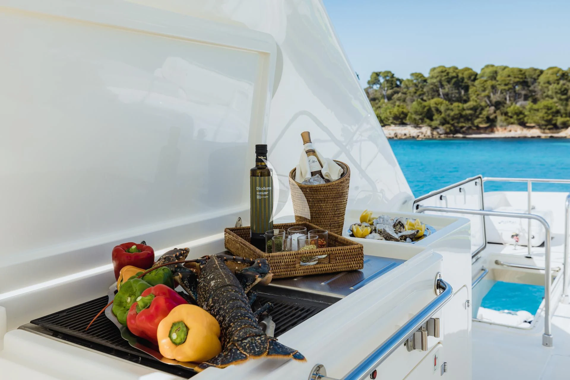 a picnic table with food and drinks on it by the ocean aboard ONYX Yacht for Charter