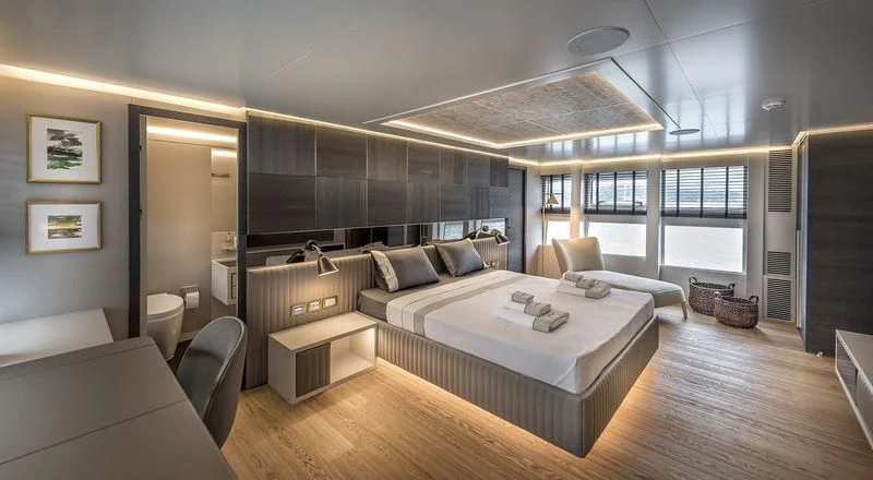 a large room with a bed and a desk aboard MARLA Yacht for Sale