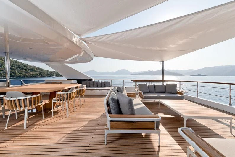 a room with a couch and a table and chairs aboard MARLA Yacht for Sale