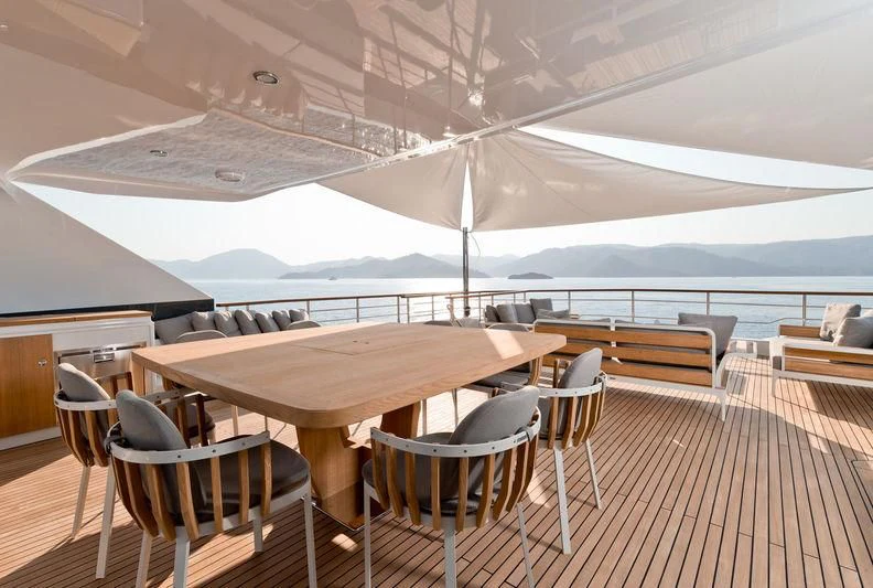 a patio with tables and chairs aboard MARLA Yacht for Sale