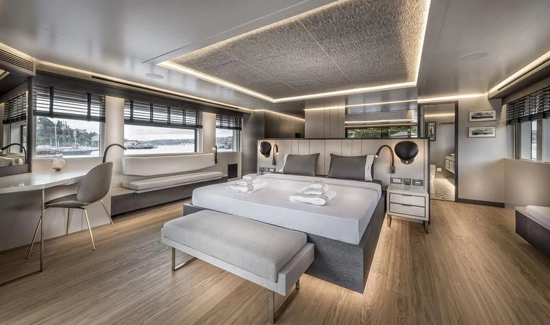 a room with a bed and a table aboard MARLA Yacht for Sale