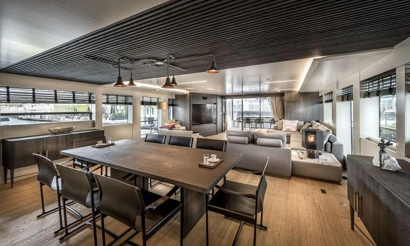 a large living room with a large table and a large window aboard MARLA Yacht for Sale