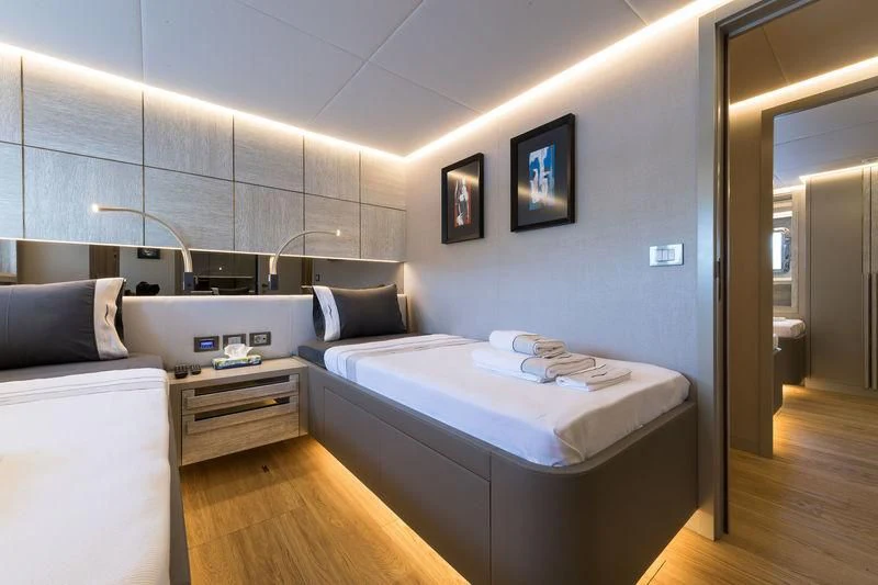 a bedroom with a bed and a desk aboard MARLA Yacht for Sale