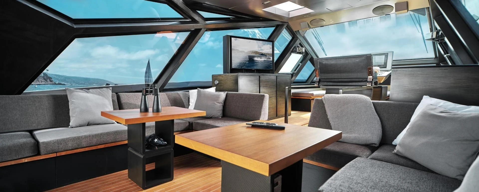 a room with a couch and a table and a tv aboard AIFOS Yacht for Sale