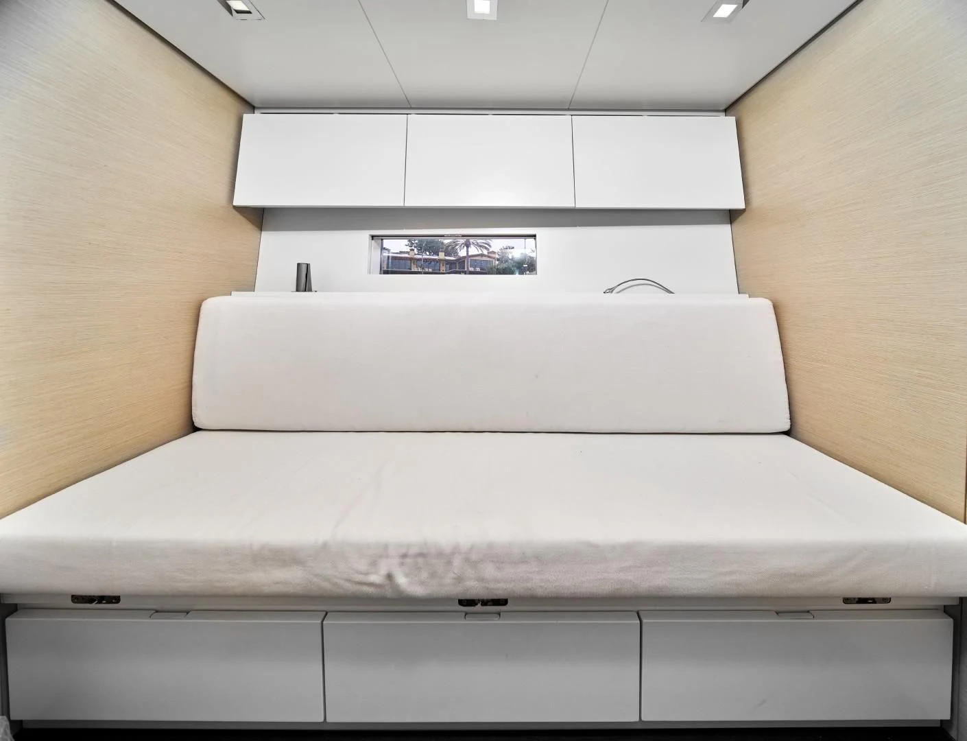 a white couch with a laptop on it aboard AIFOS Yacht for Sale