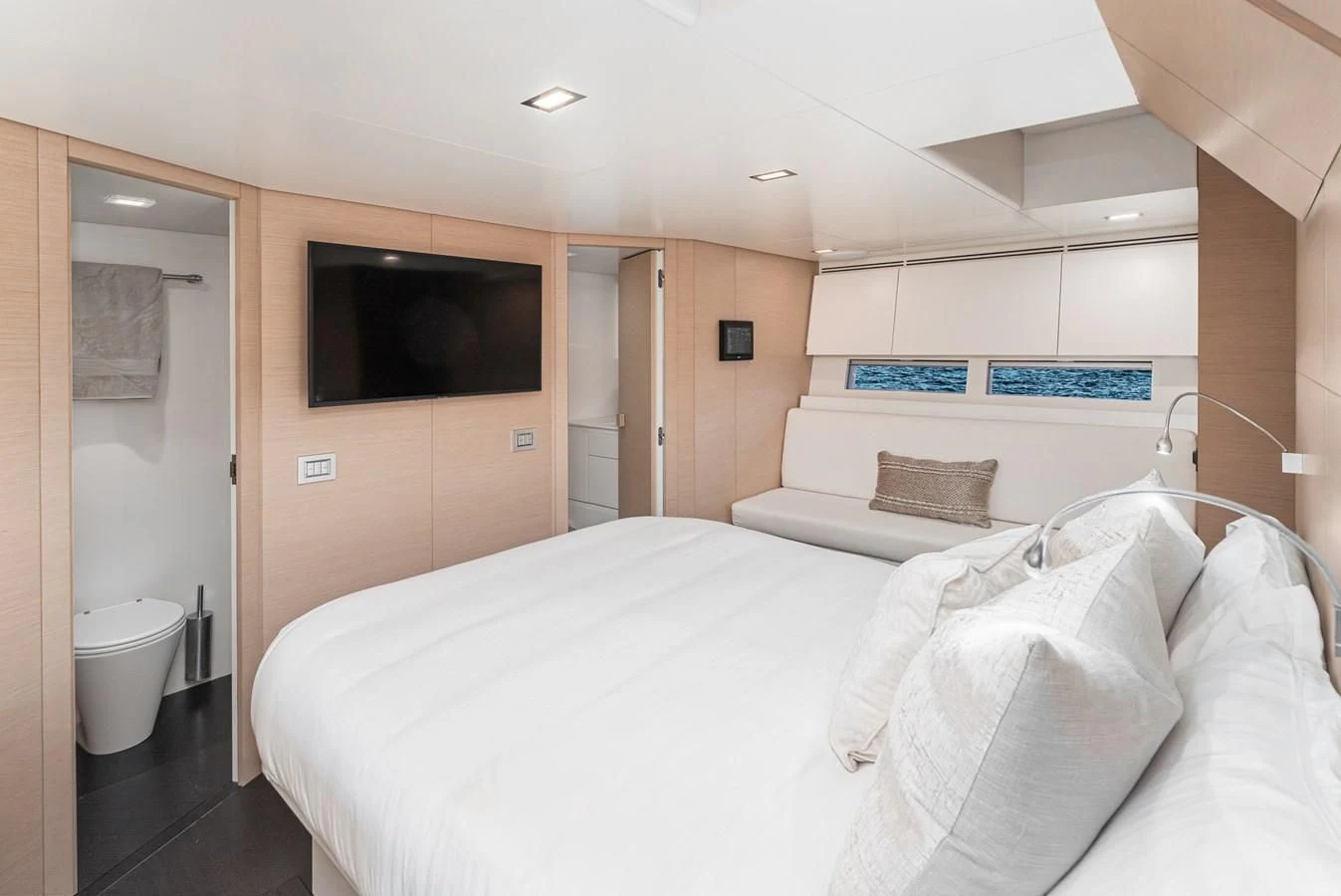 a hotel room with a bed and tv aboard AIFOS Yacht for Sale