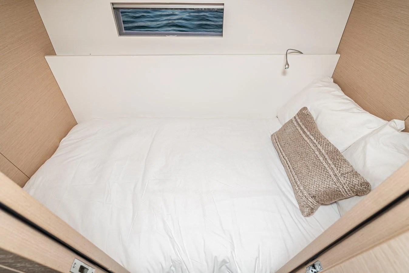 a bed with a white comforter aboard AIFOS Yacht for Sale