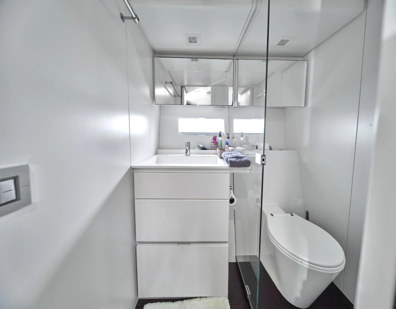 a bathroom with a toilet sink and a mirror aboard AIFOS Yacht for Sale