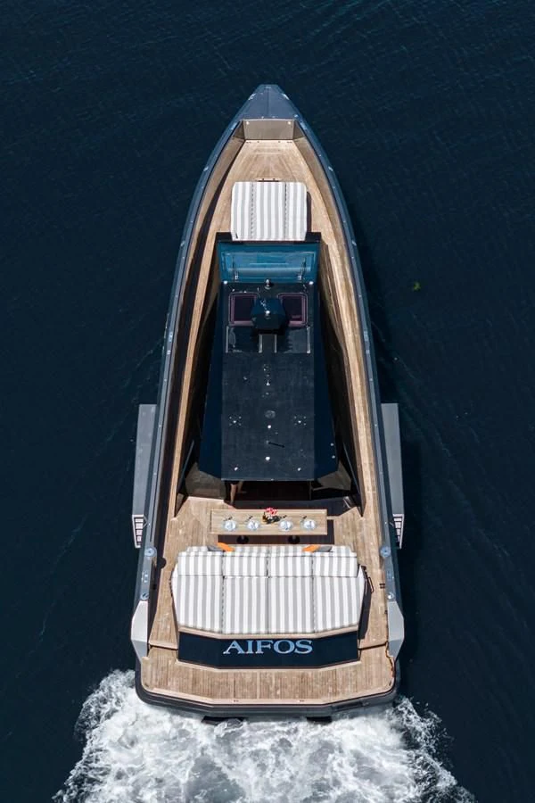 a wooden boat on a body of water aboard AIFOS Yacht for Sale