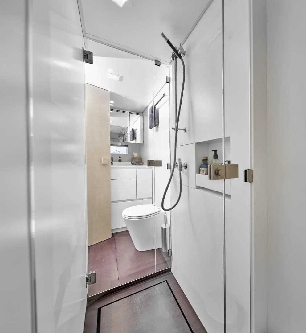 a bathroom with a toilet and shower aboard AIFOS Yacht for Sale