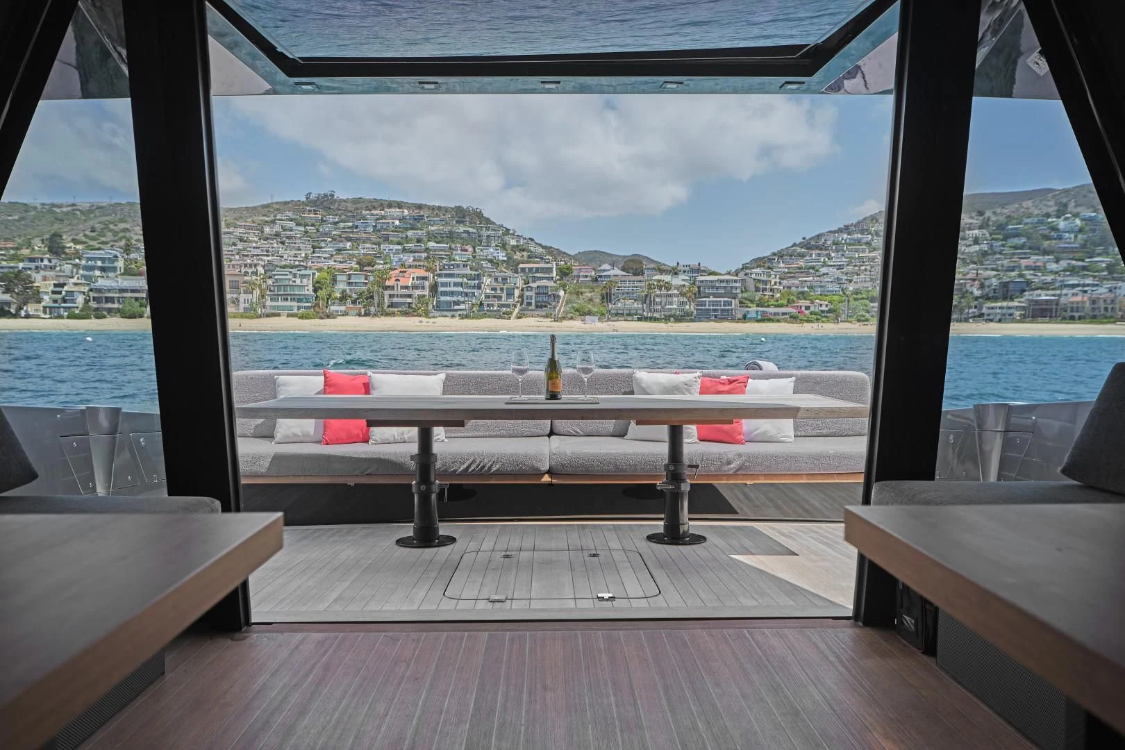 a room with a view of the ocean and a city aboard AIFOS Yacht for Sale