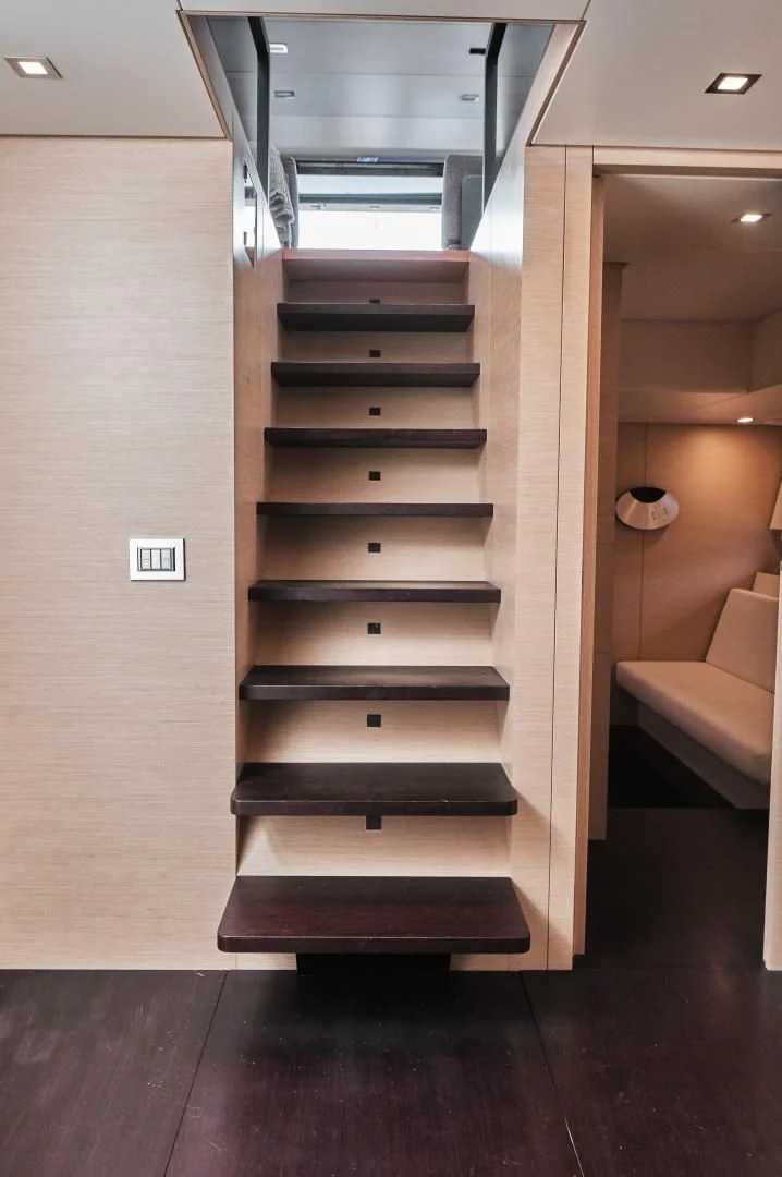 a wooden staircase in a room aboard AIFOS Yacht for Sale
