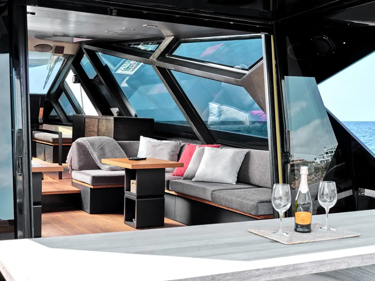a glass of beer and a table on a boat aboard AIFOS Yacht for Sale