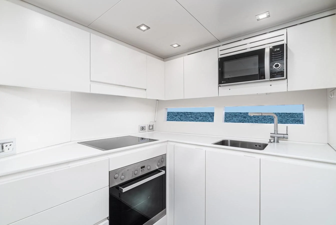 a kitchen with white cabinets aboard AIFOS Yacht for Sale