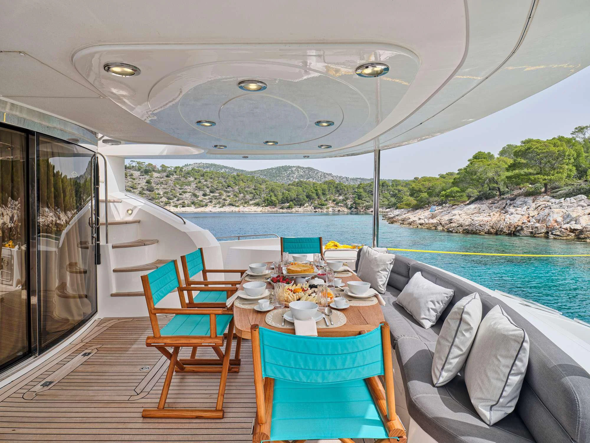a table set for a meal on a boat aboard M FIVE Yacht for Charter