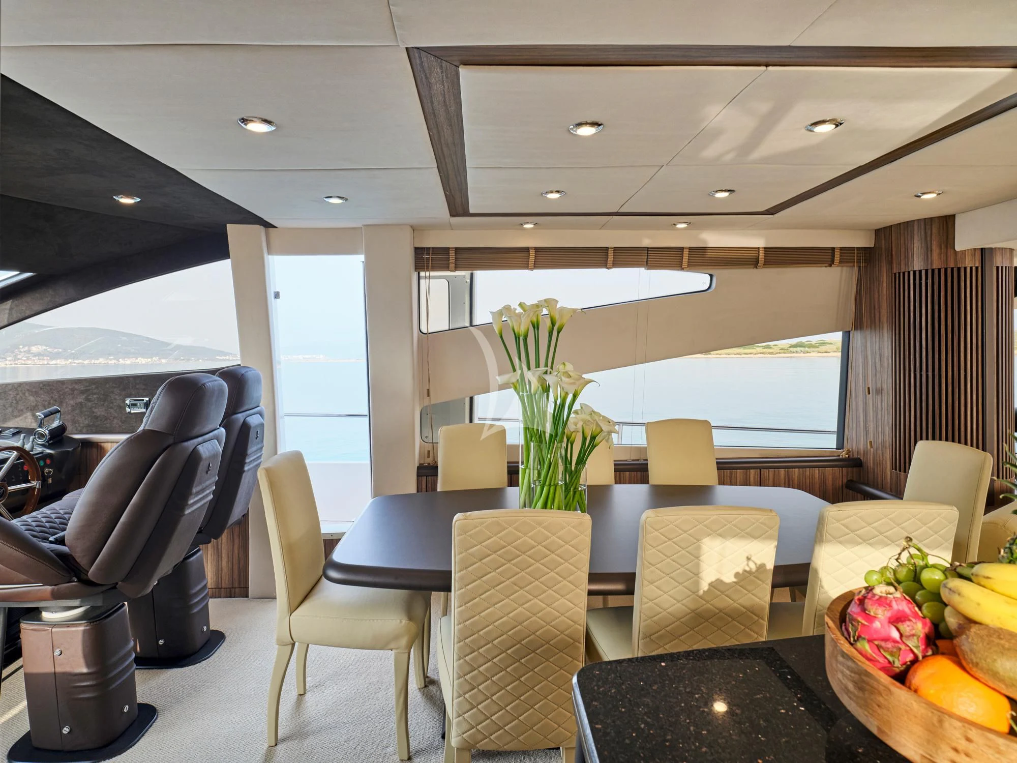 a room with a table chairs and plants in it aboard M FIVE Yacht for Charter