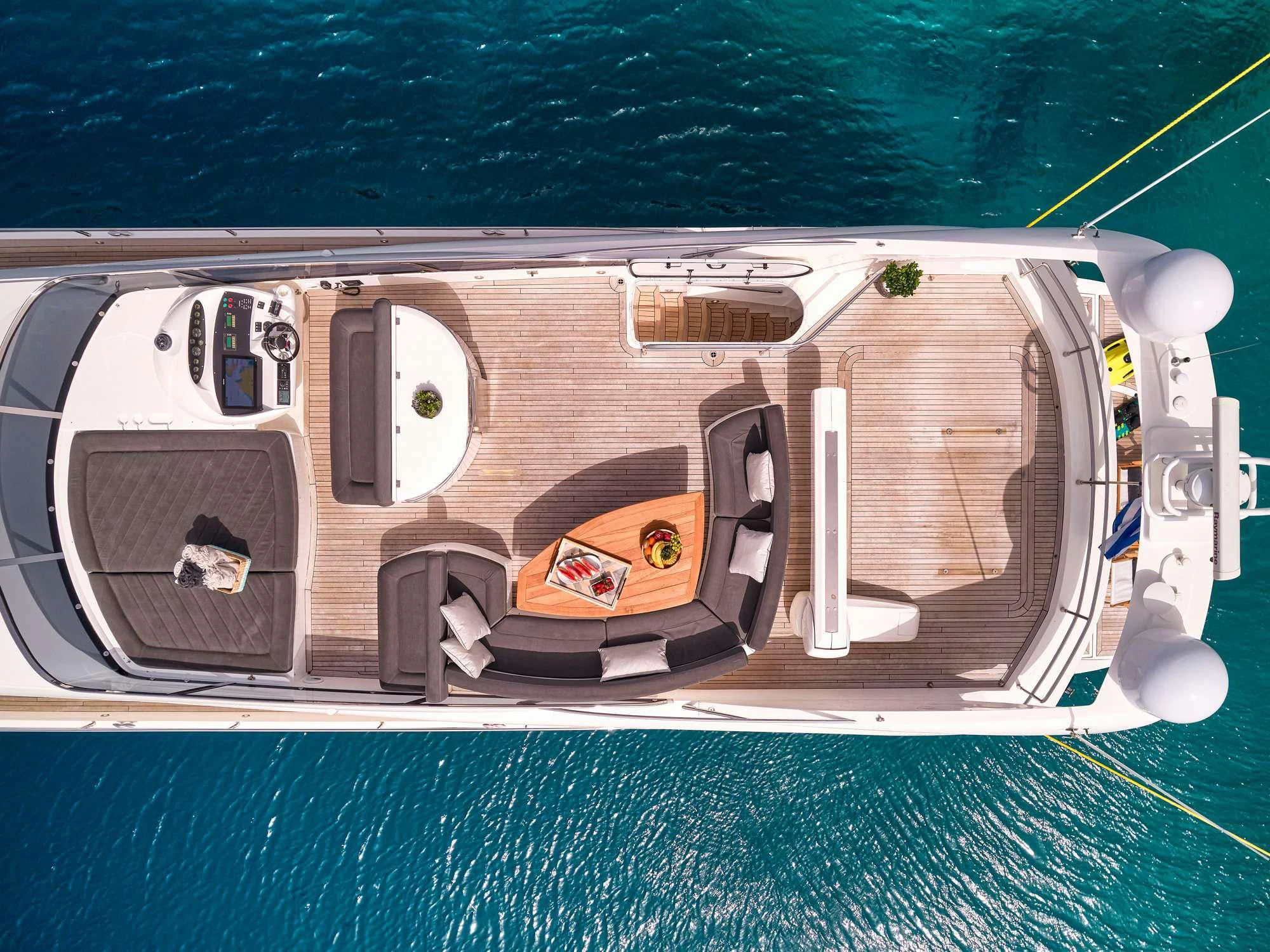 a white vehicle on a blue surface aboard M FIVE Yacht for Charter