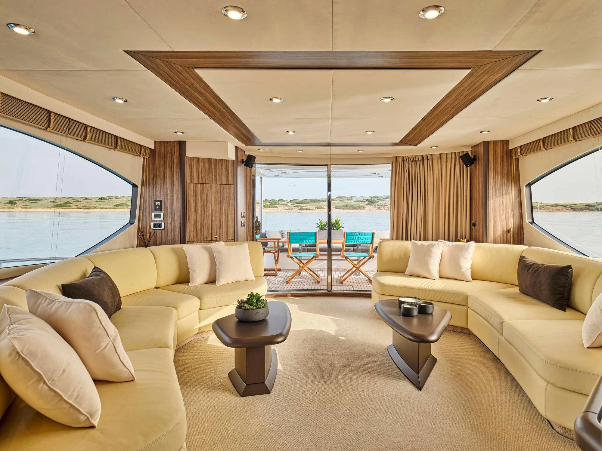 a living room with a large window aboard M FIVE Yacht for Charter