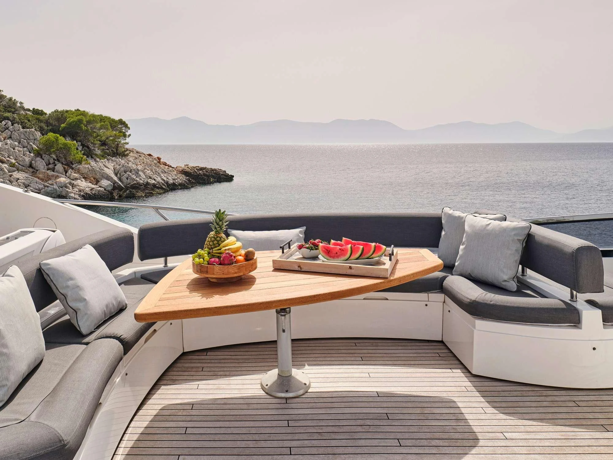 a table with fruit on it aboard M FIVE Yacht for Charter