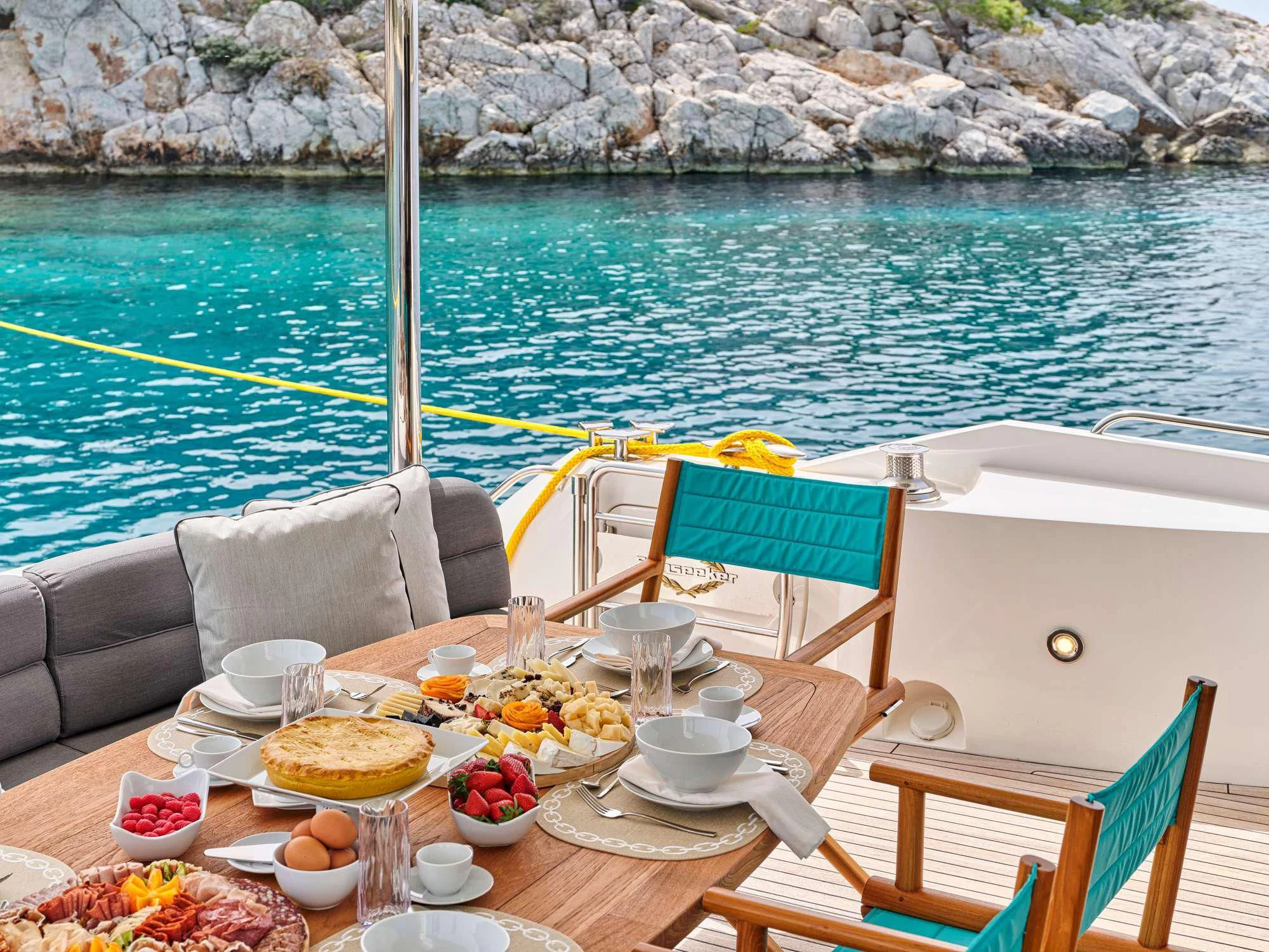 a table with food on it aboard M FIVE Yacht for Charter