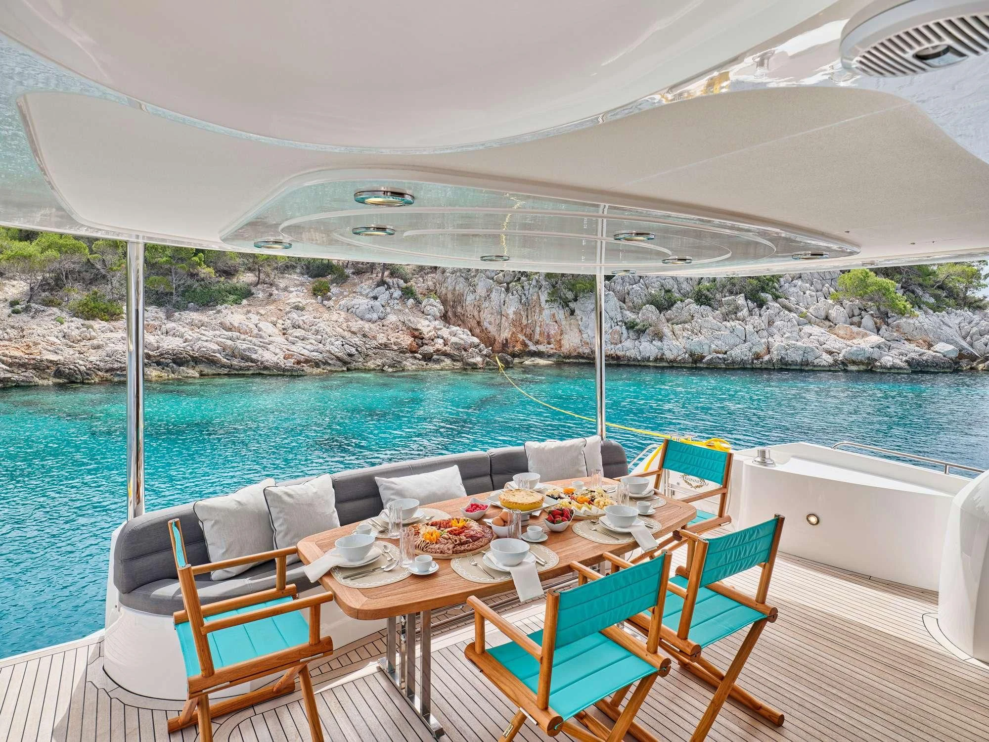 a table set for a meal on a boat aboard M FIVE Yacht for Charter