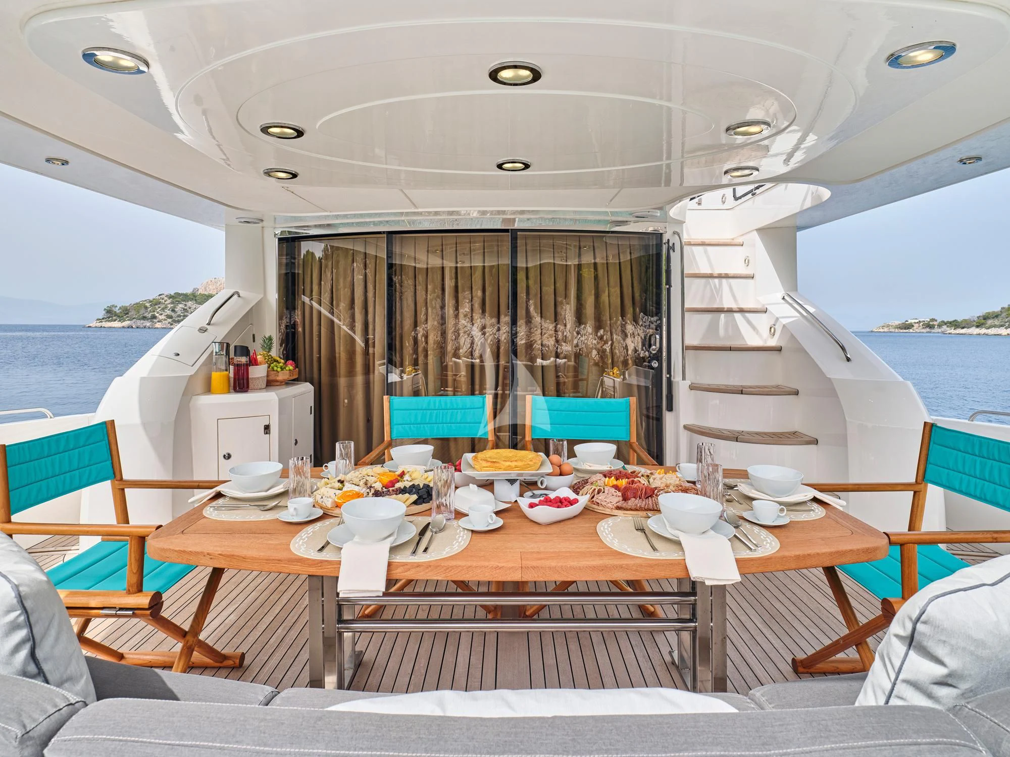 a table set for a meal on a boat aboard M FIVE Yacht for Charter